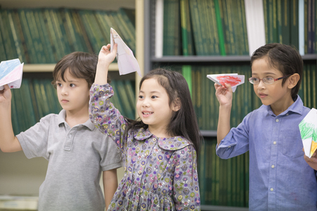Portrait of Children playing airplane at classroom together, Children with education concept.の写真素材