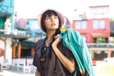 Portrait of Happy Traveler Woman in city. Woman with Travel Concept.の写真素材