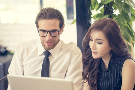 Businessman Talking for Business at Cafe, Charming Young Woman Present for Business Plan, People Working Concept, Vintage Tone.の写真素材