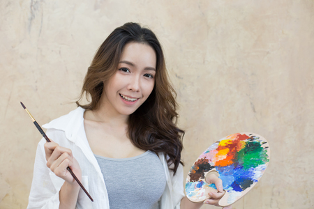 Asian woman painting in her studio. People with art concept.の写真素材