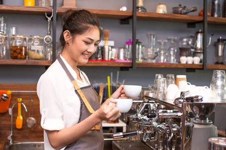 Asian Barista woman making Coffee with coffee machine in the coffee shop. people with barista in cafe concept.の写真素材
