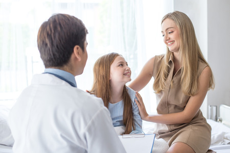 Doctor visit to little patient at hospital with happy emotion together. People with health care and medical concept.の写真素材