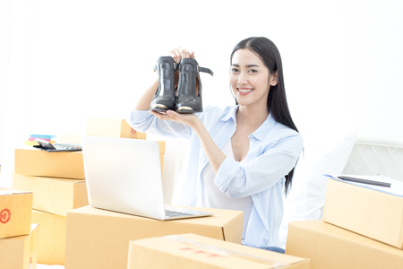 Young Asian Woman success for online business, Young Owner Woman Start up for Business Online. People with online shopping SME entrepreneur or freelance working concept.の写真素材