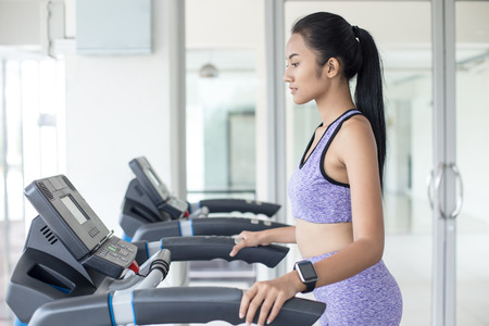 Woman exercise at fitness gym. Sport and Reaction concept.