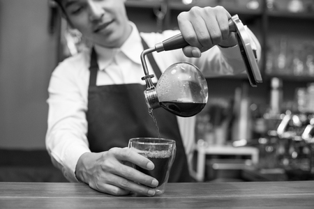 Barista making coffee for customer. Black and White tone.の写真素材