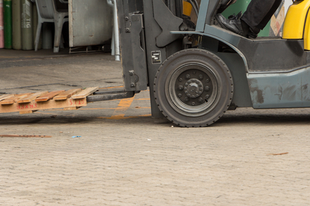 worker drive truck to lift a wood pallet for material movement.