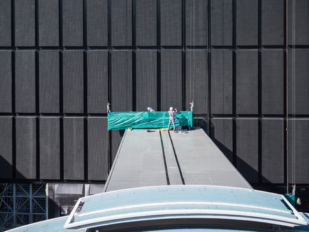 worker prepare tools before climb to high level by lift. Maintenance outside building on high level...