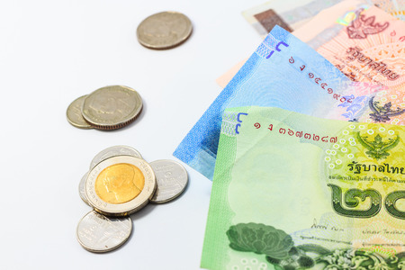 Heap of Thai baht Bills and coin on white backgroundの写真素材
