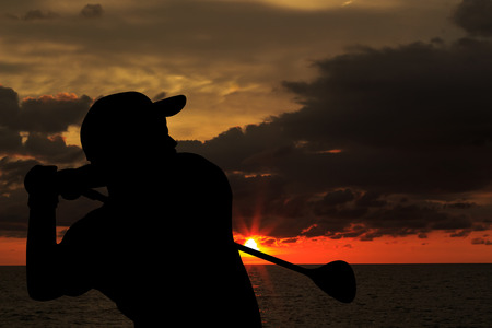 silhouette golfer  beautiful sky backlit sunset background.の写真素材