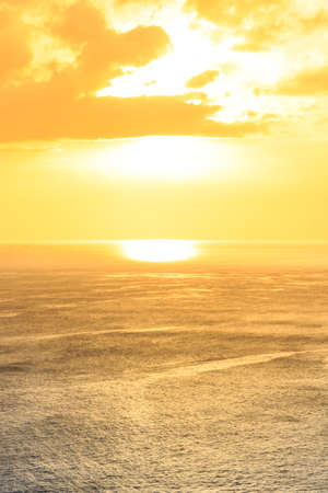 Beautiful yellow orange sunset above the seaの写真素材