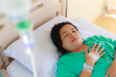Close up of a woman patient in hospital with saline intravenous (iv)の写真素材