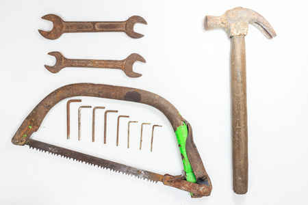 Old Rusty Hammer  wrench Screwdriver and saw on white backgroundの写真素材