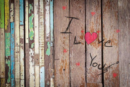 word i love you on old rustic wooden table background top viewの写真素材