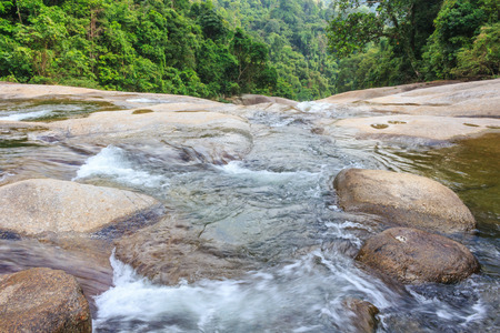 Waterfall in tropical forest. Mountain river, stones with moss,Thailandの写真素材