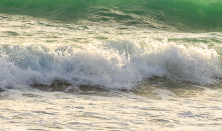 A beautiful blue wave breaks in the oceanの写真素材