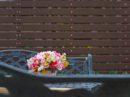 Flowerpot on vintage table and bench in outdoor garden and battens background, Copy Space, Vintageの写真素材