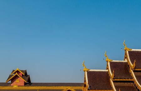 Roof Style of Thai Temple on Blue Sky Background in Northern Thailand, Copy Spaceの写真素材
