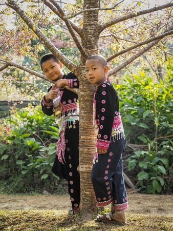 CHIANG MAI, THAILAND - JANUARY 26, 2015: Hill tribes child under the tree. Hmong new year festival day.のeditorial素材