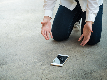 Felling Sad Person Droped Smartphone on Floor with Copy Spaceの写真素材