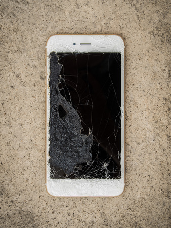 Top View of Crack Screen Smart Phone on the Floor, Close Upの写真素材