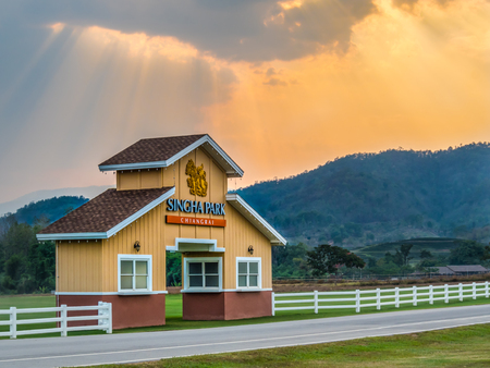CHIANG RAI, THAILAND - MAY 11 : Country Style Gate on Field with Mountain and Two Tone Sky Background at Singha Park, Chiang rai province, Thailandのeditorial素材