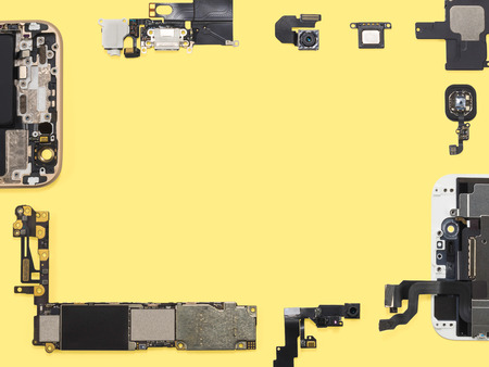 Flat lay (top view) of smart phone components isolate on yellow background with copy spaceの写真素材