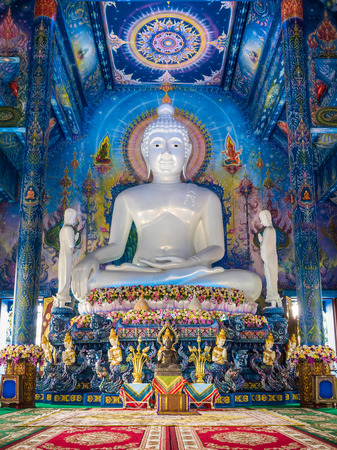 Big white jade statue of "the Buddha calling the earth to witness or earth touching Buddha" and wonderful mural in blue chapel at the temple in Chiang-Rai, Thailandのeditorial素材
