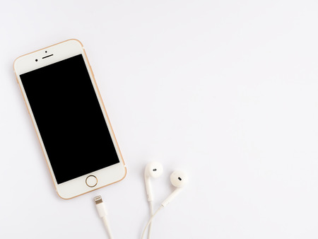 CHIANGRAI, THAILAND -SEPTEMBER 9, 2016: Close-up image of new Apple iPhone 7 mockup and new Apple EarPods mockup on white background with copy space.のeditorial素材