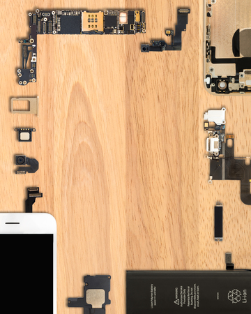 Flat Lay (Top view) of smartphone components on wooden background with copy space in 4:5 aspect ratioの写真素材