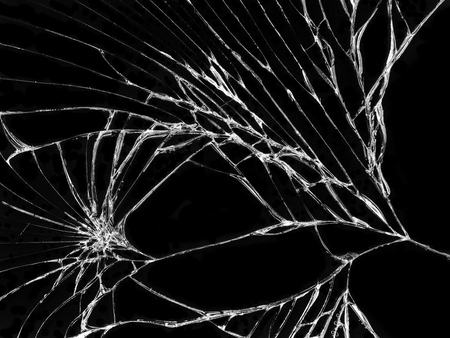 Cracked glass texture on black background. Isolated realistic cracked glass effect.の写真素材