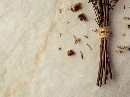 Close-up bouquet of four dried and wilted Gypsophila flowers on matt marble background with copy spaceの写真素材