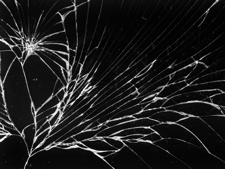 Cracked glass texture on black background. Isolated realistic cracked glass effect.の写真素材