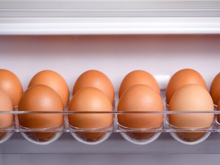 Organic chicken eggs are one of the food ingredients in the egg compartment in the refrigerator....