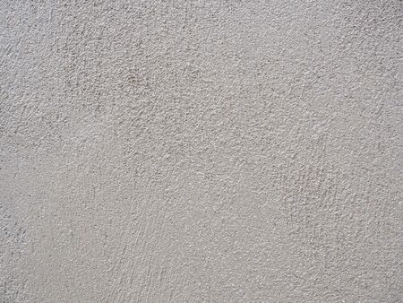 Close-up shot of rough unfinished plaster concrete texture. Use as a background imageの写真素材