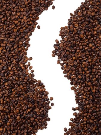 Close-up and top view of roasted Thai coffee beans and empty area for copy space on white background for used as background, backdrop or bannerの写真素材