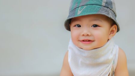 Close-up of Asian adorable toddler kid in good mood smiling happily and relaxed with copy space. Baby care and childhood concept.の写真素材