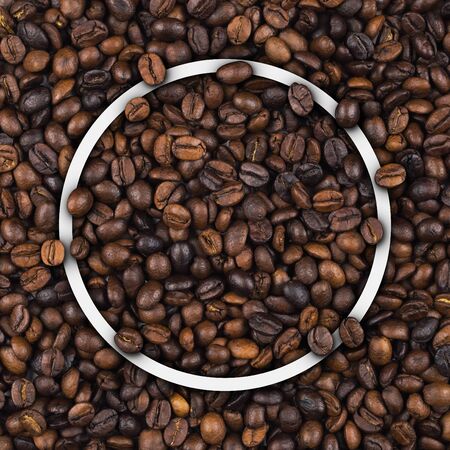 Closeup of empty white outline border frame on heap of roasted coffee beans for use as coffee web banner, coffee shop sign or cafe.の写真素材