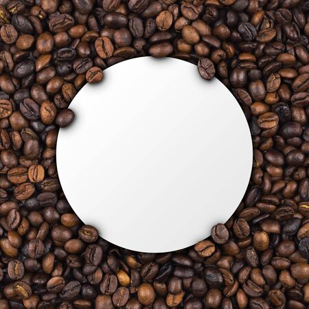 Closeup of empty white label paper on heap of roasted coffee beans for use as coffee web banner, coffee shop sign or cafe.の写真素材