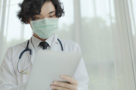 Doctor in white uniform and medical mask with stethoscope. Copy space