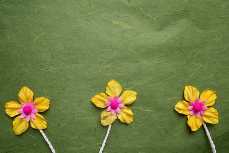 Artificial flower  on mulberry paper backgroundの写真素材