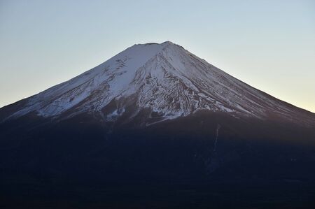 a light yellow sunset light shined on mount fujiの写真素材