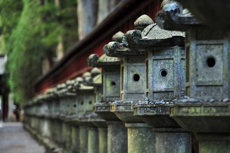old japanese stone lantern row in a templeの写真素材