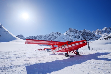 a red plane landing on a glacier in alaskaのeditorial素材