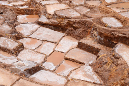 Inca ancient salt farm produced by evaporation in Peru