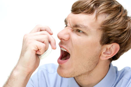 nervous young businessman swearing on the phone