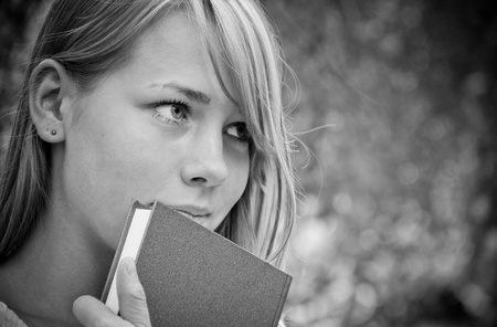 beautiful girl in the park with booksの写真素材