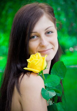 Portrait of a cute young female with flowerの写真素材