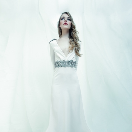 fashion portrait of a sensual girl in a white dressの写真素材