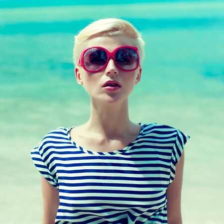 fashion portrait of a girl on a background of the sea
