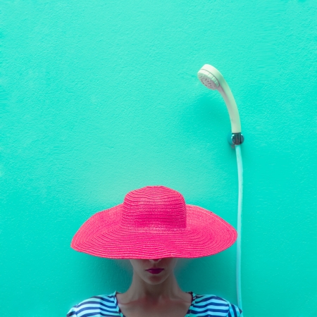 portrait of a girl in a hat in the showerの写真素材